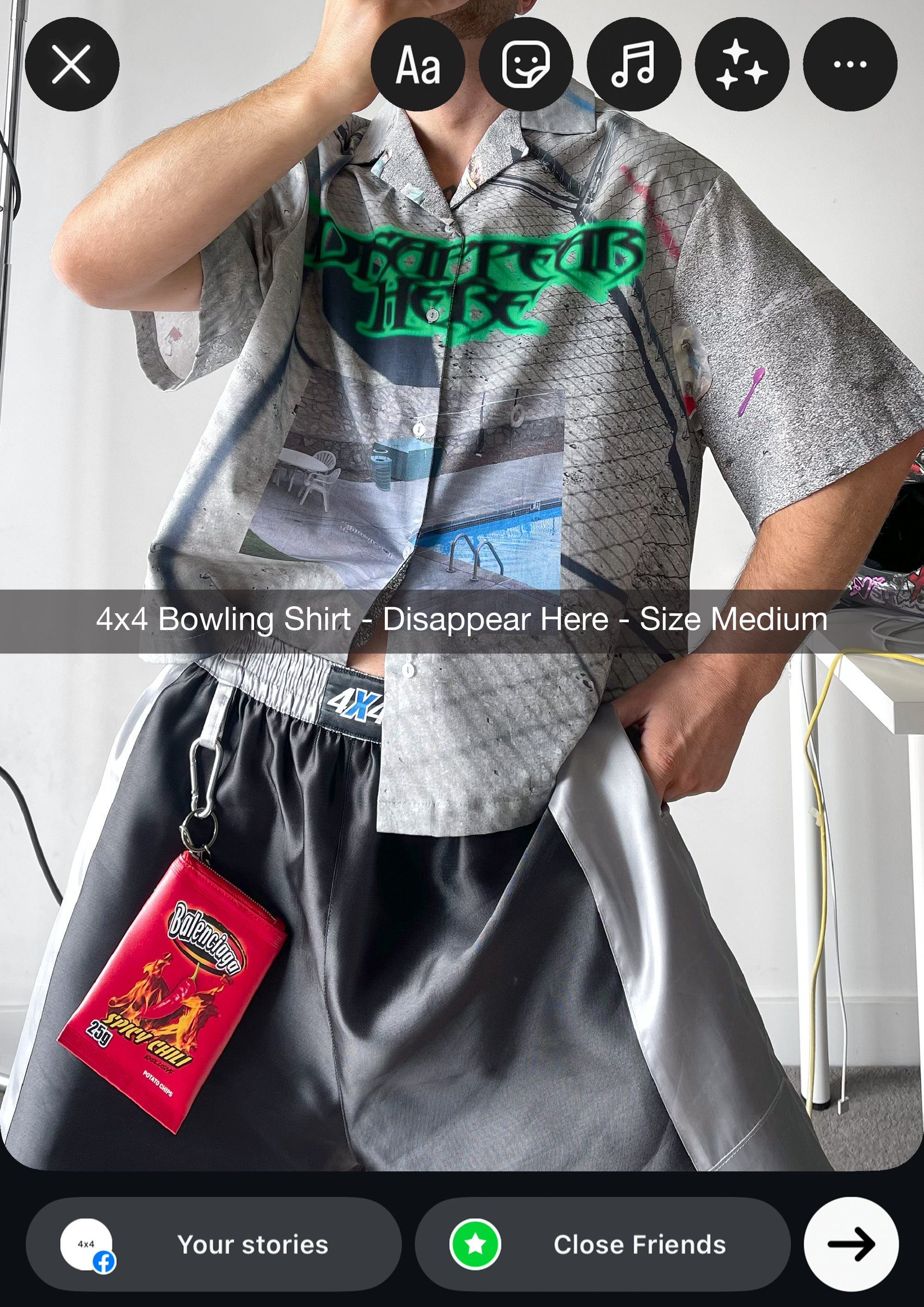 Person wearing a gray 4x4 bowling shirt with a visible brand tag on a white background