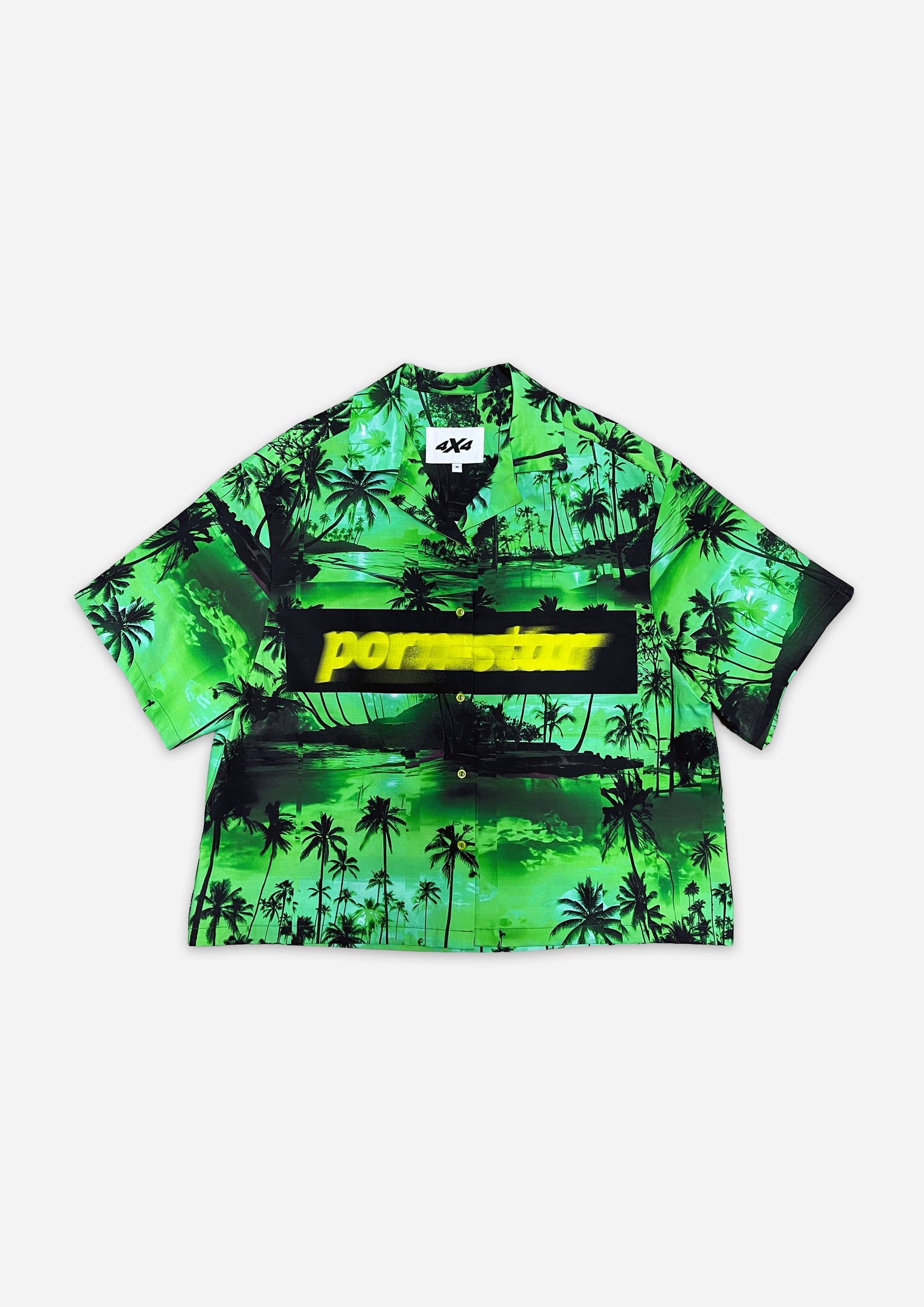 Green tropical patterned shirt with a brand logo on a white background