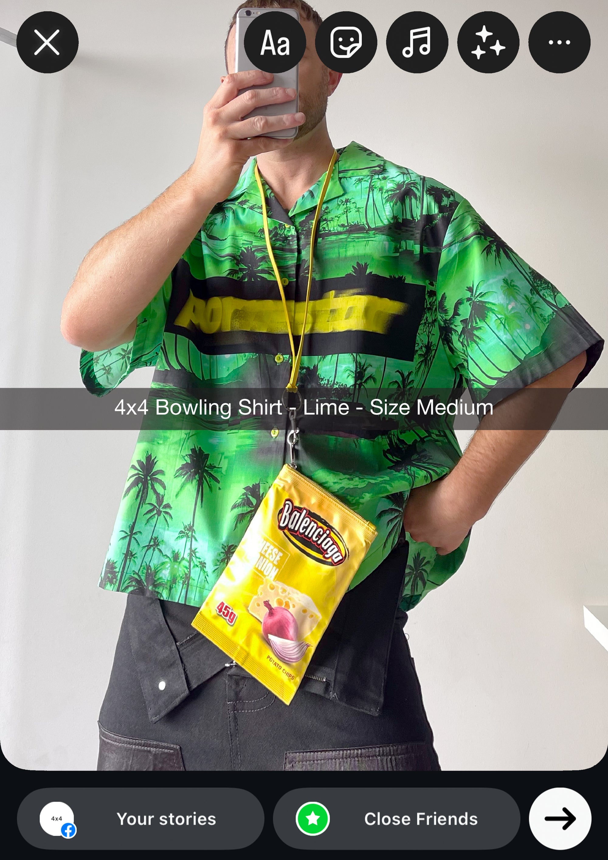 Person wearing a green patterned shirt with a yellow lanyard and product package.