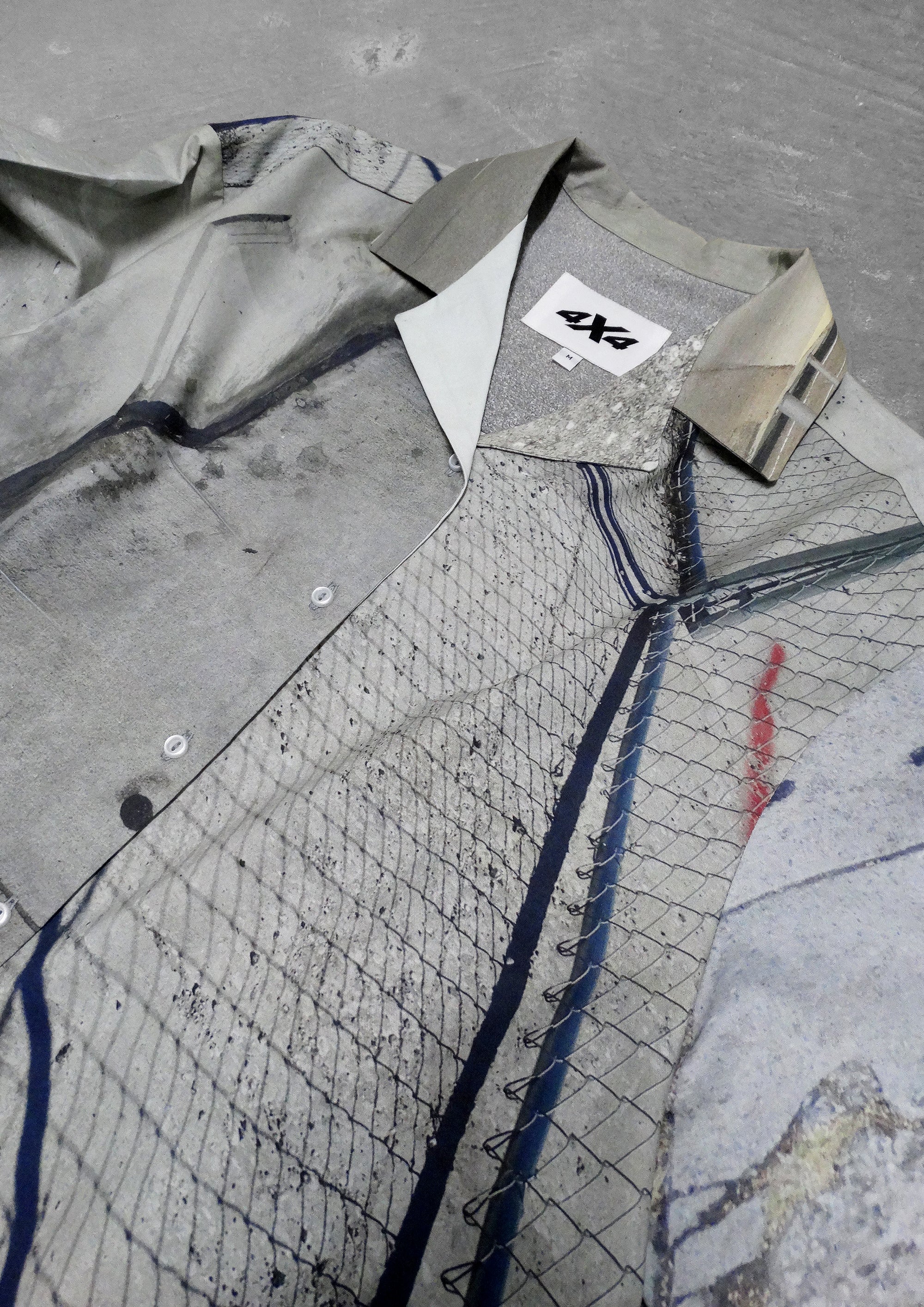 Gray jacket with a brand logo on a textured surface