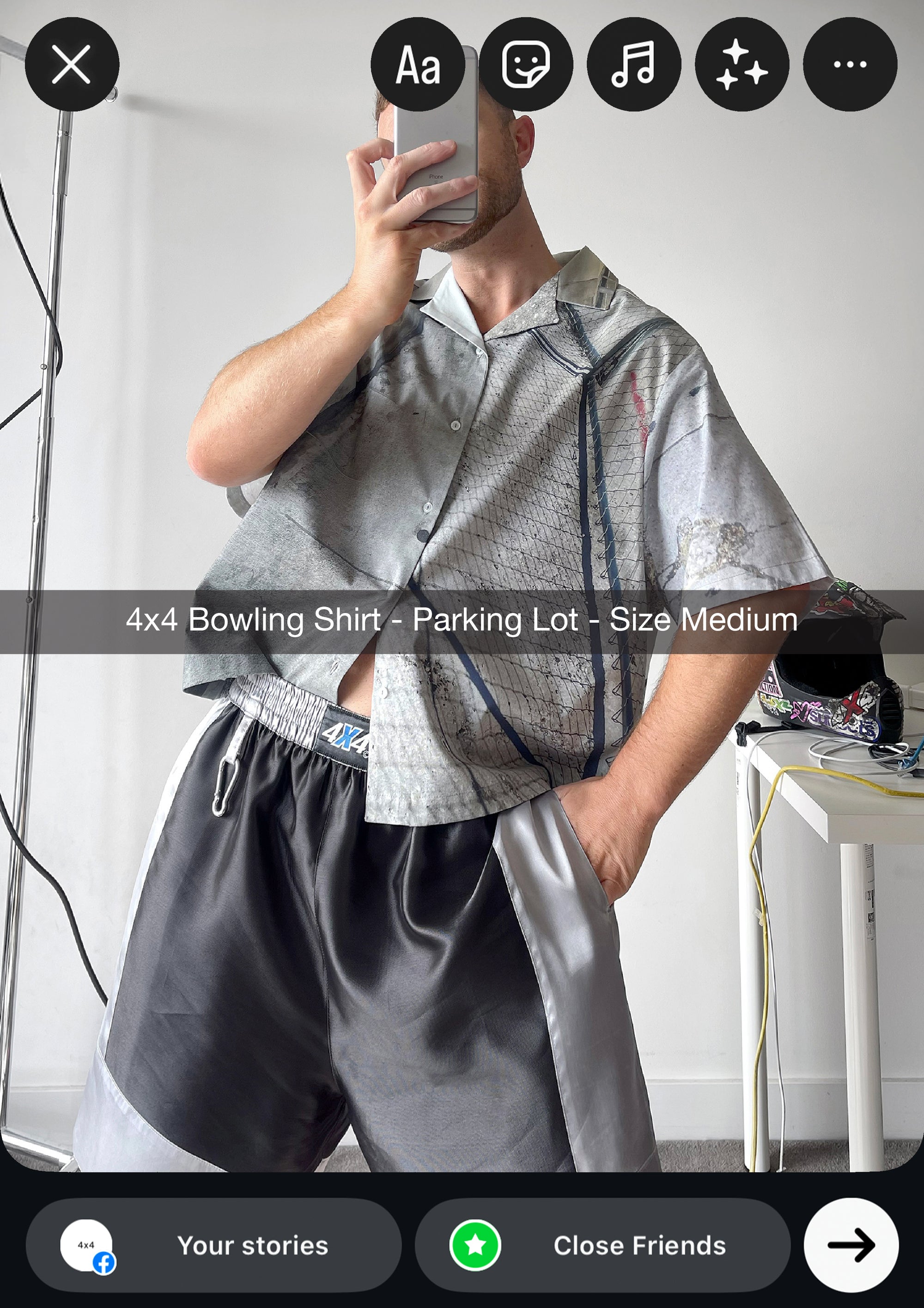 Person wearing a 4x4 Bowling Shirt and gray shorts in a minimal indoor setting.