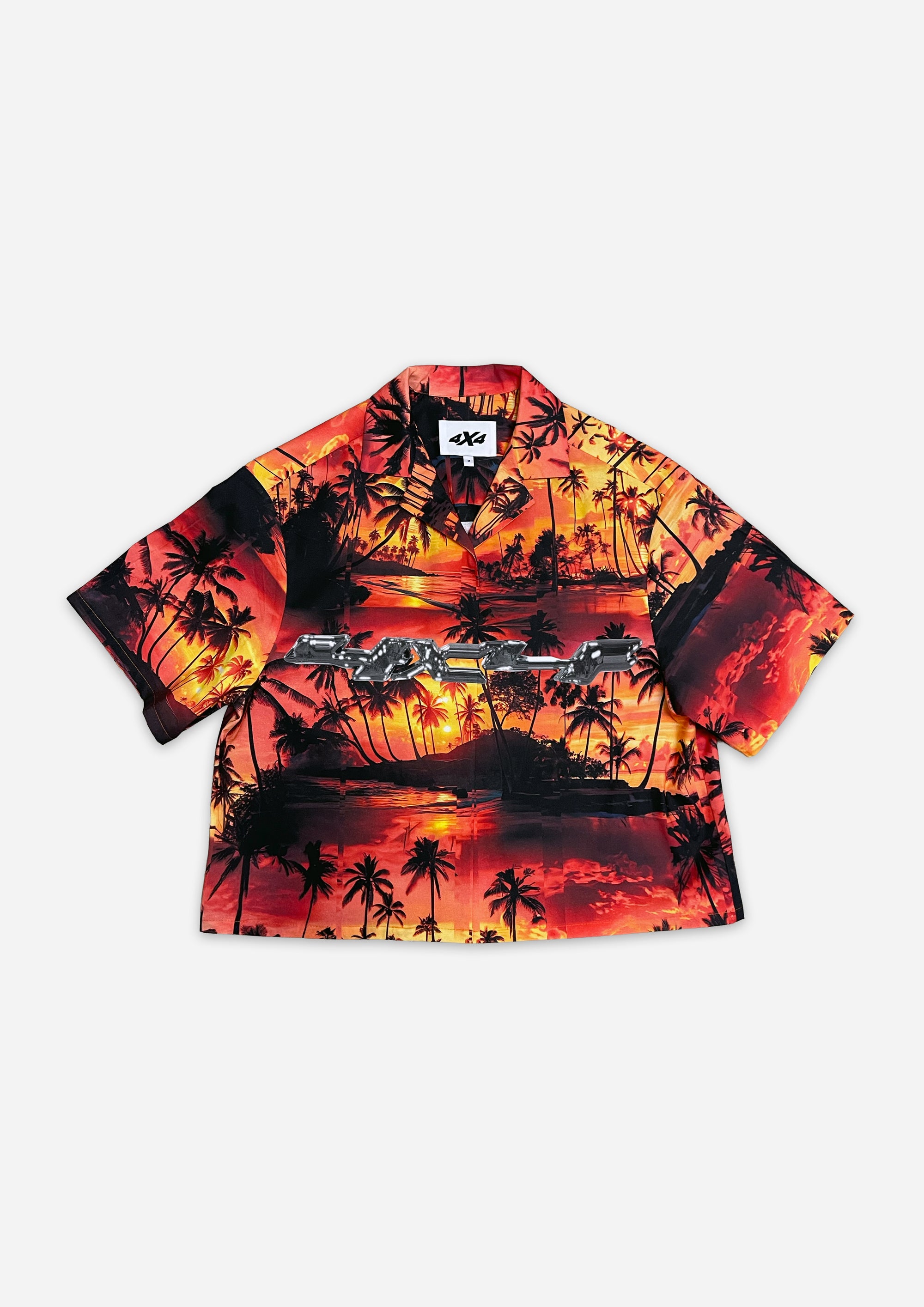 Hawaiian-style shirt with sunset and palm tree design on a white background