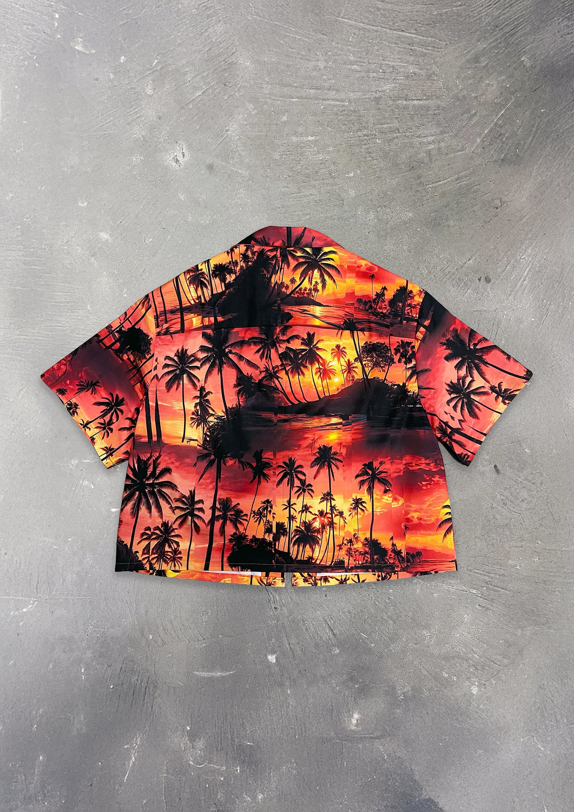 Hawaiian shirt with palm tree design on a metallic surface