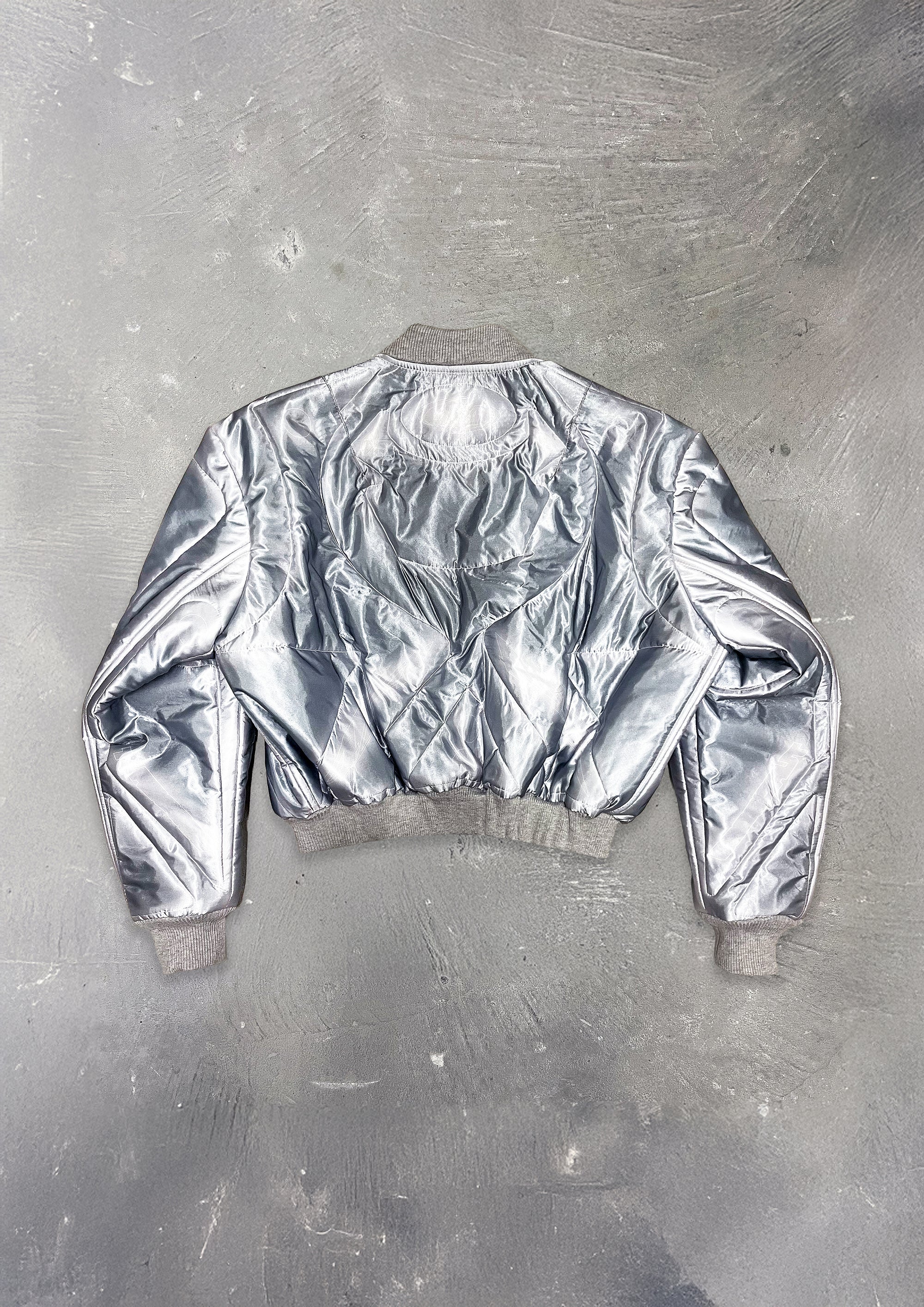Silver metallic jacket on a textured gray background