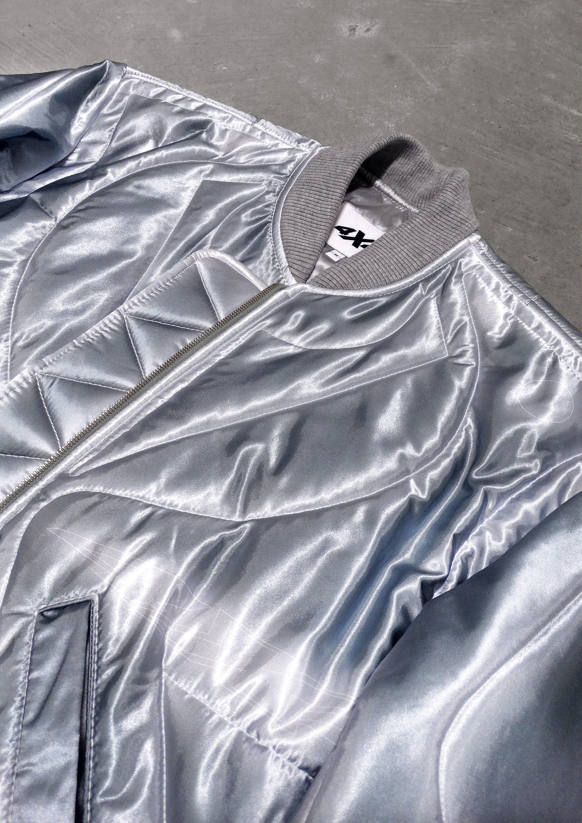 Silver reflective jacket on a textured surface