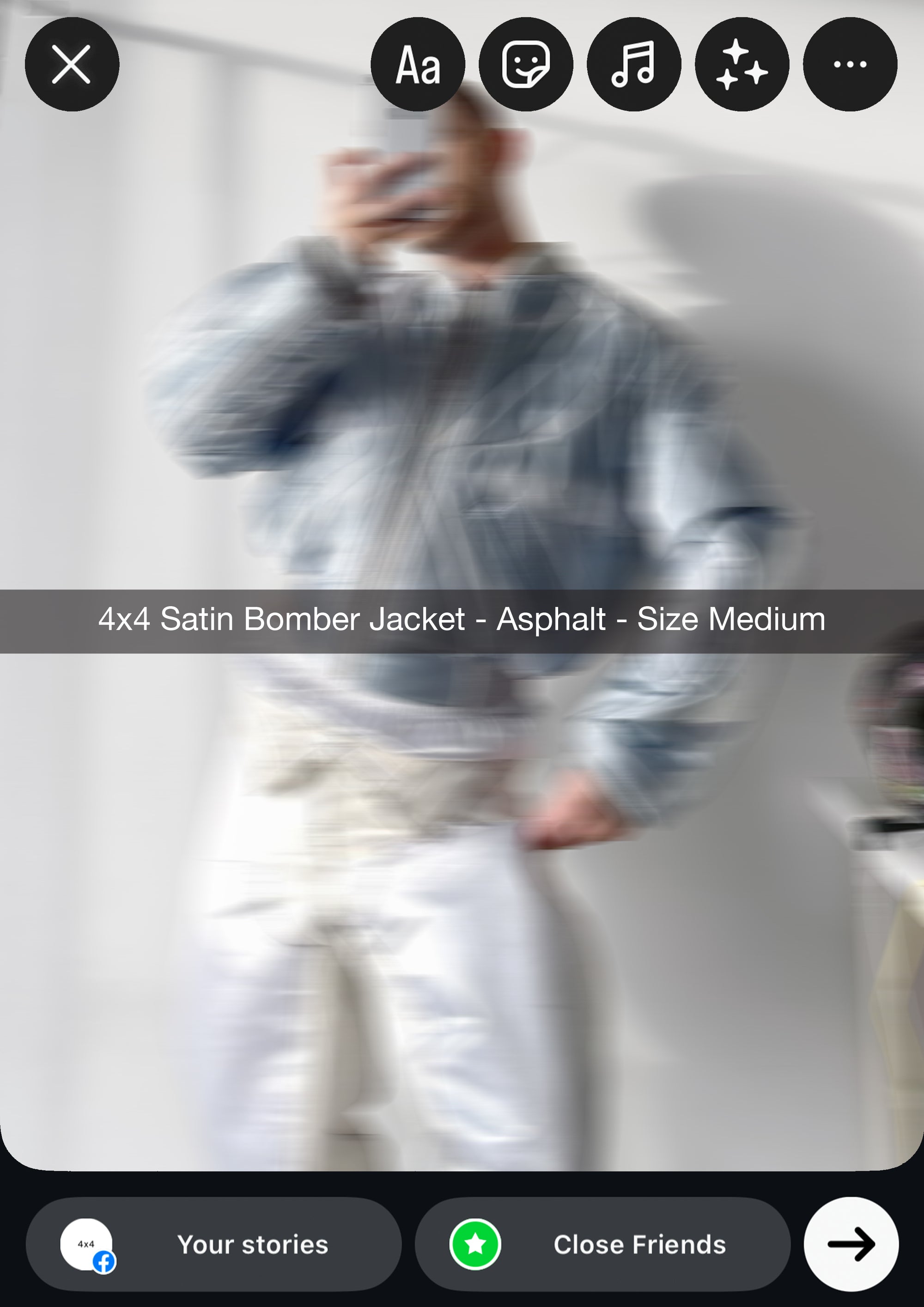 Person wearing a satin bomber jacket with product details on a blurred background