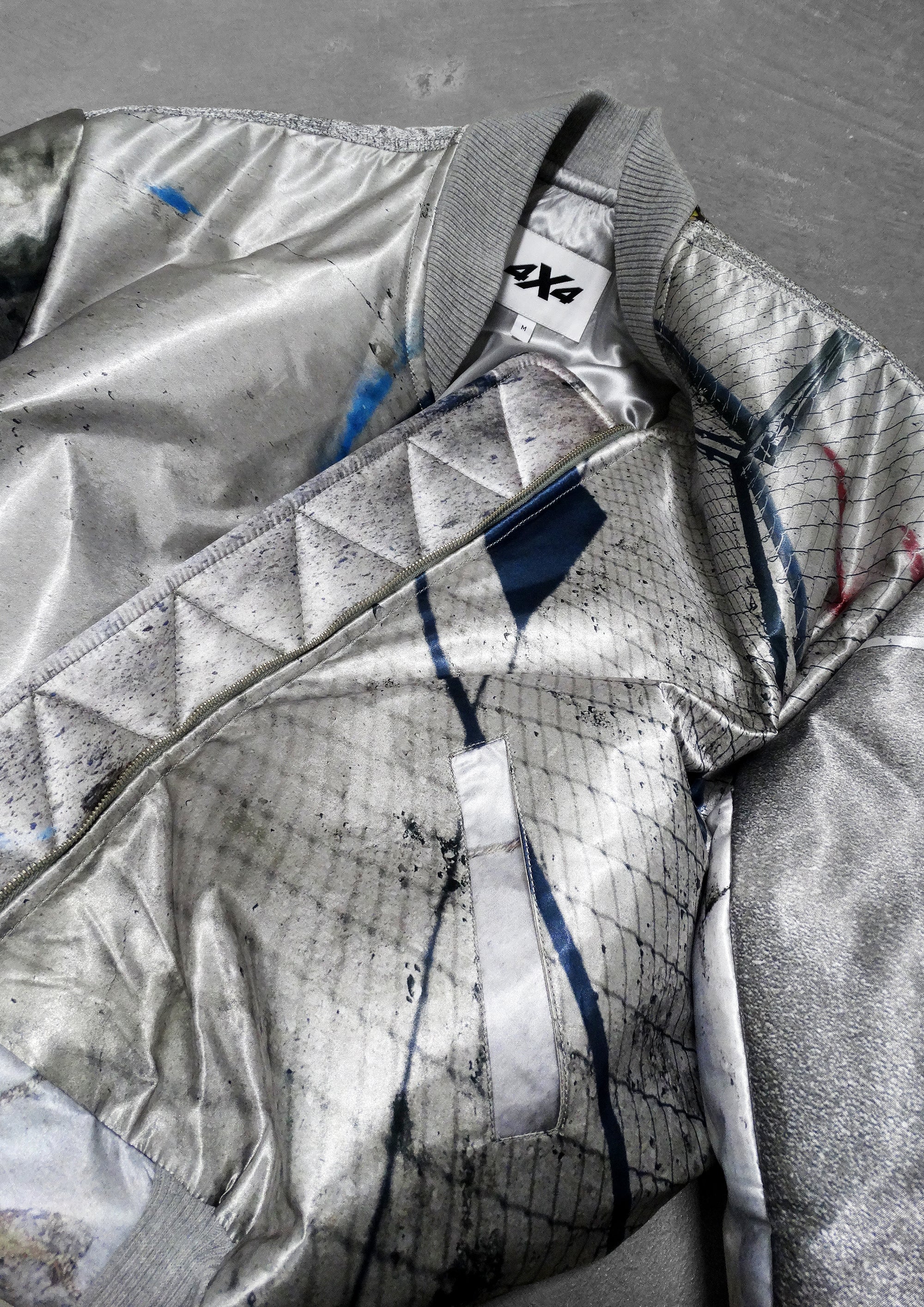Close-up of a textured fabric with a brand logo on a gray background