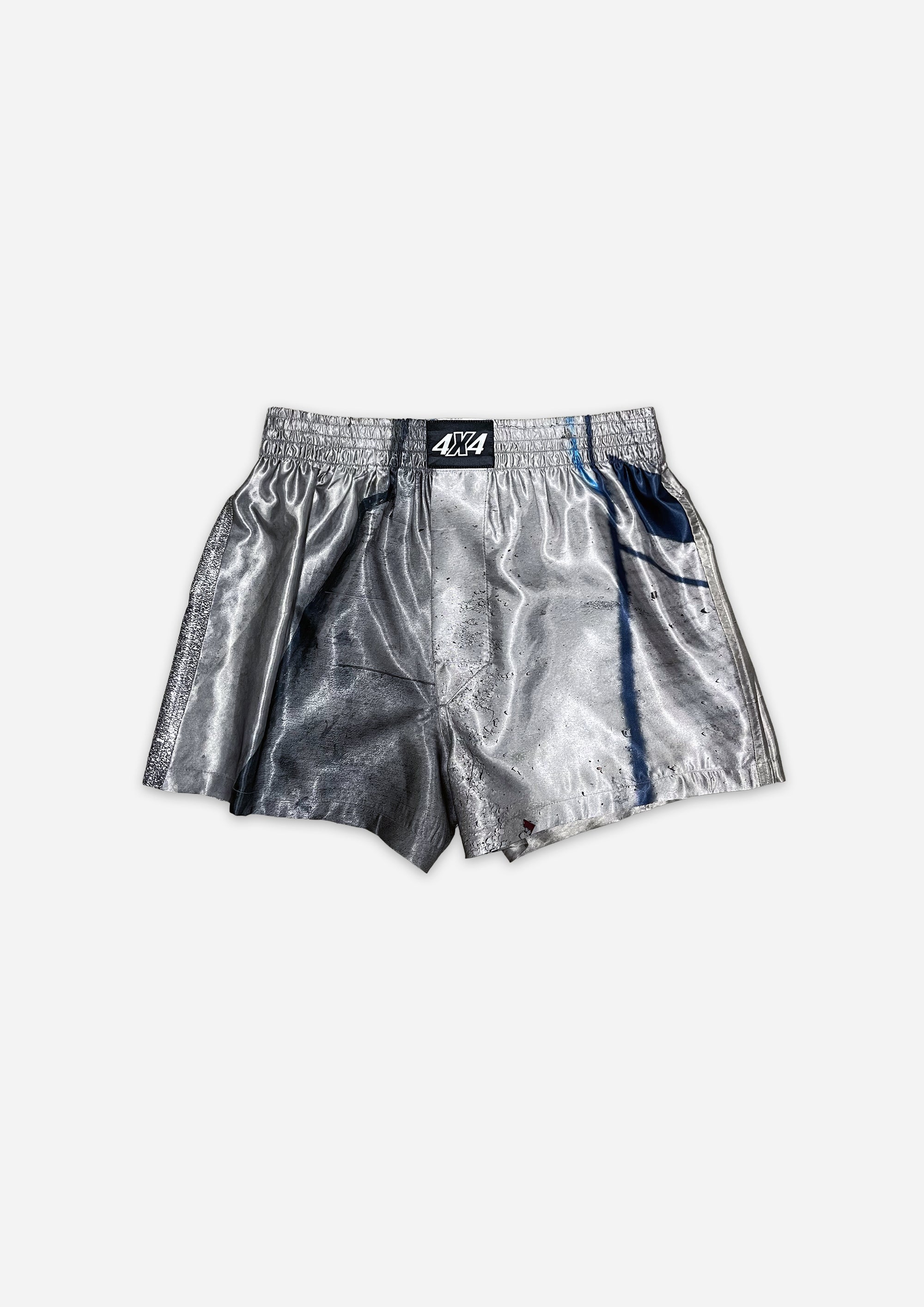 Silver metallic shorts with a brand logo on a white background