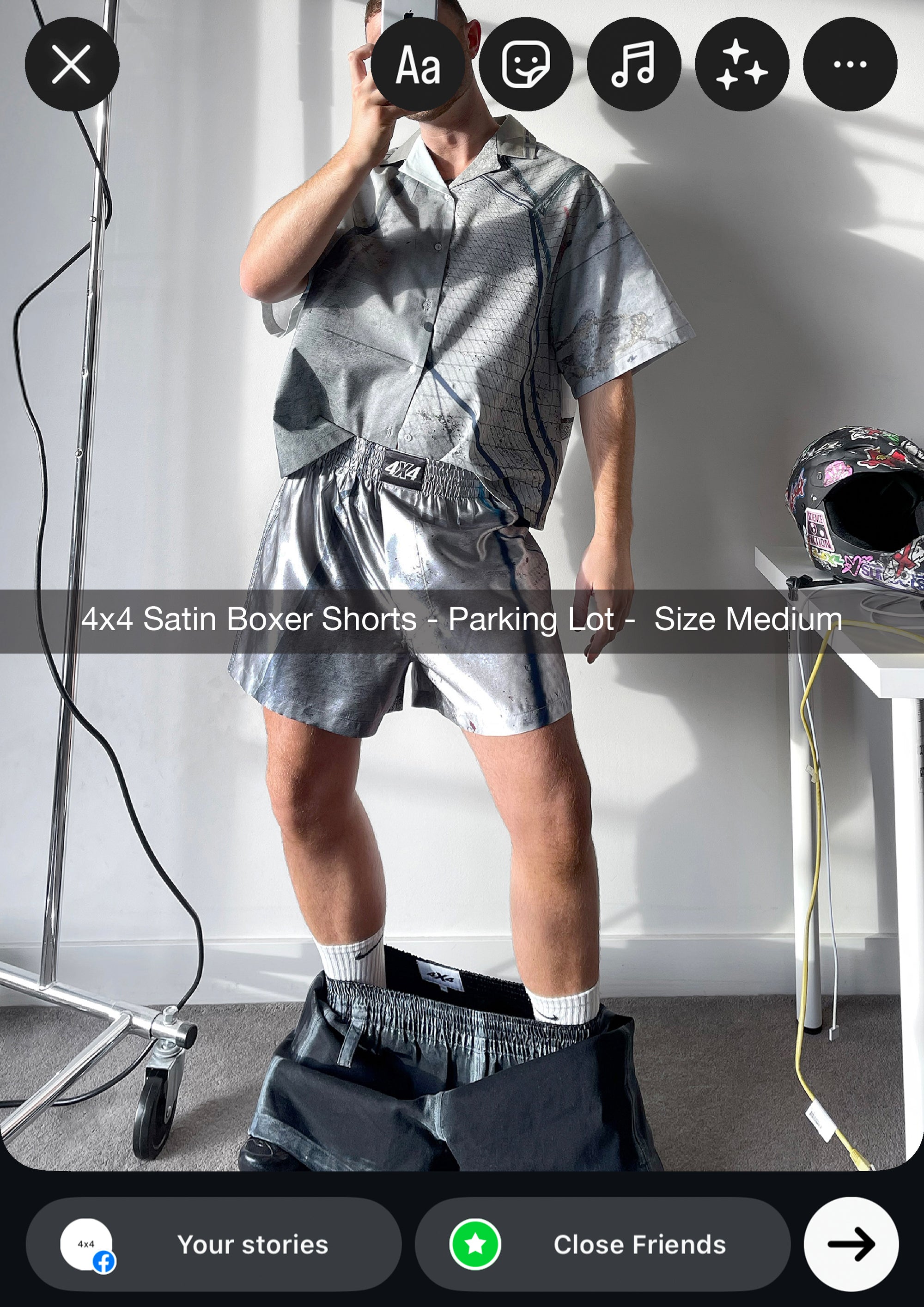 Person wearing satin boxer shorts with a neutral background