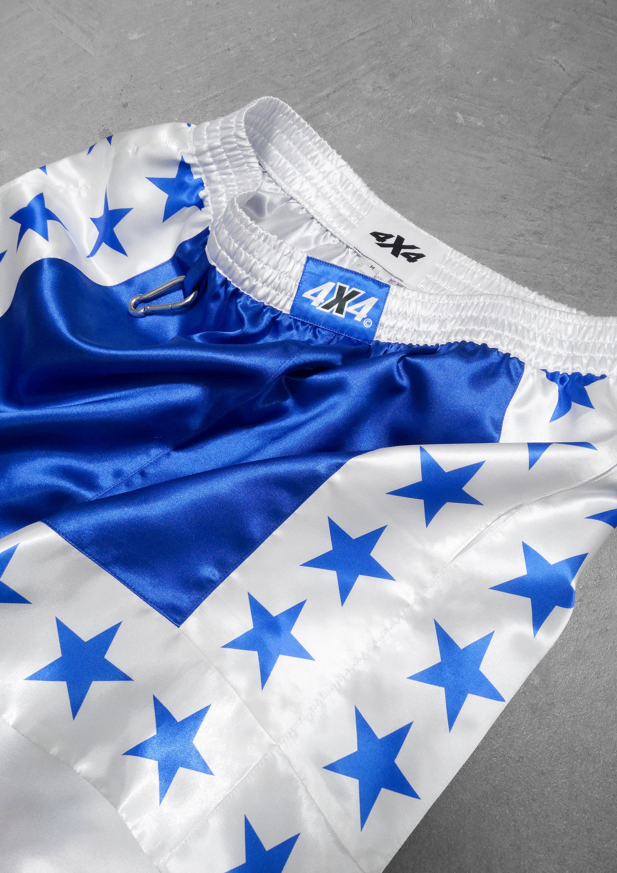White and blue sports jersey with star patterns on a gray background