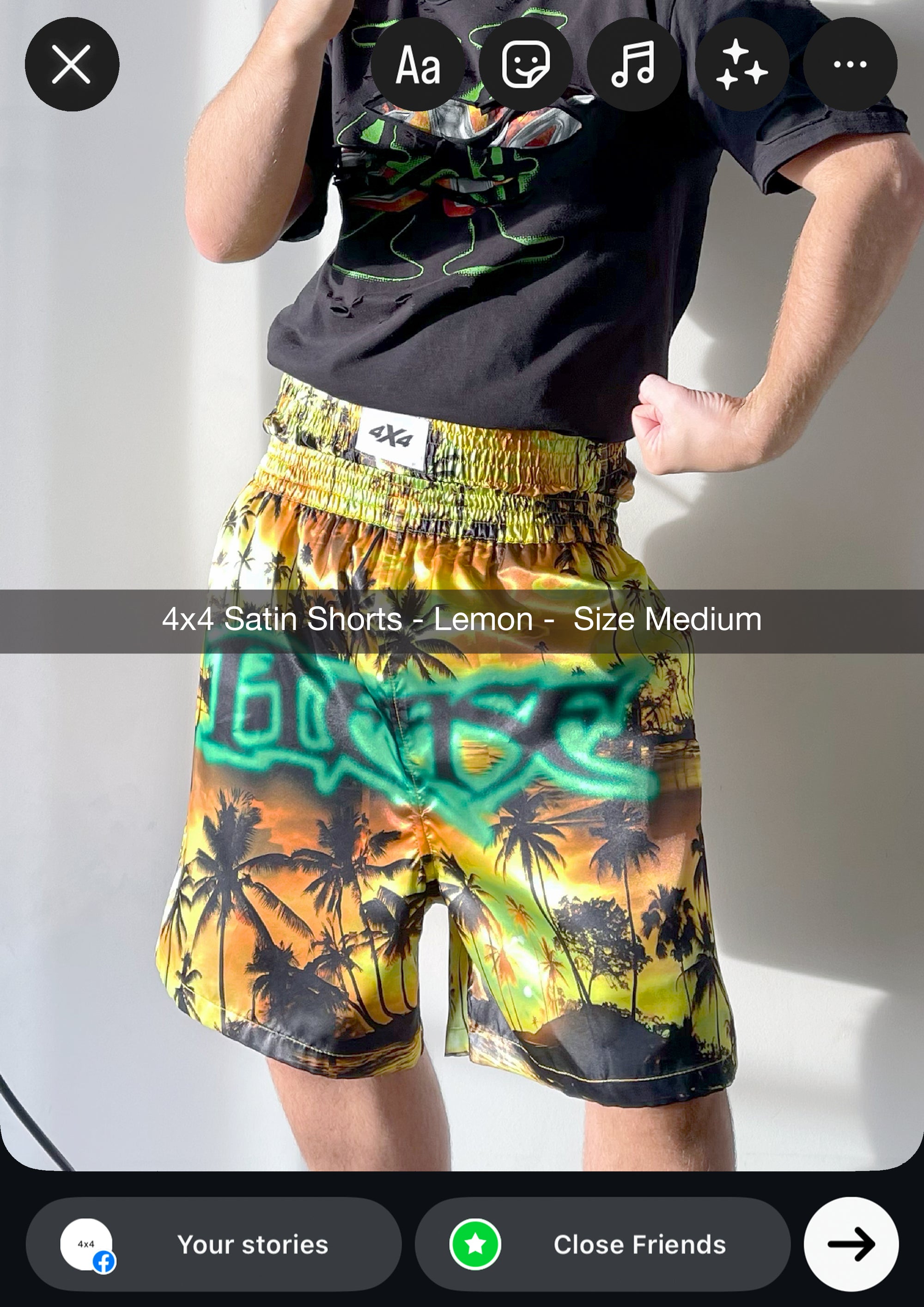 Person wearing colorful satin shorts with palm tree design on a plain background