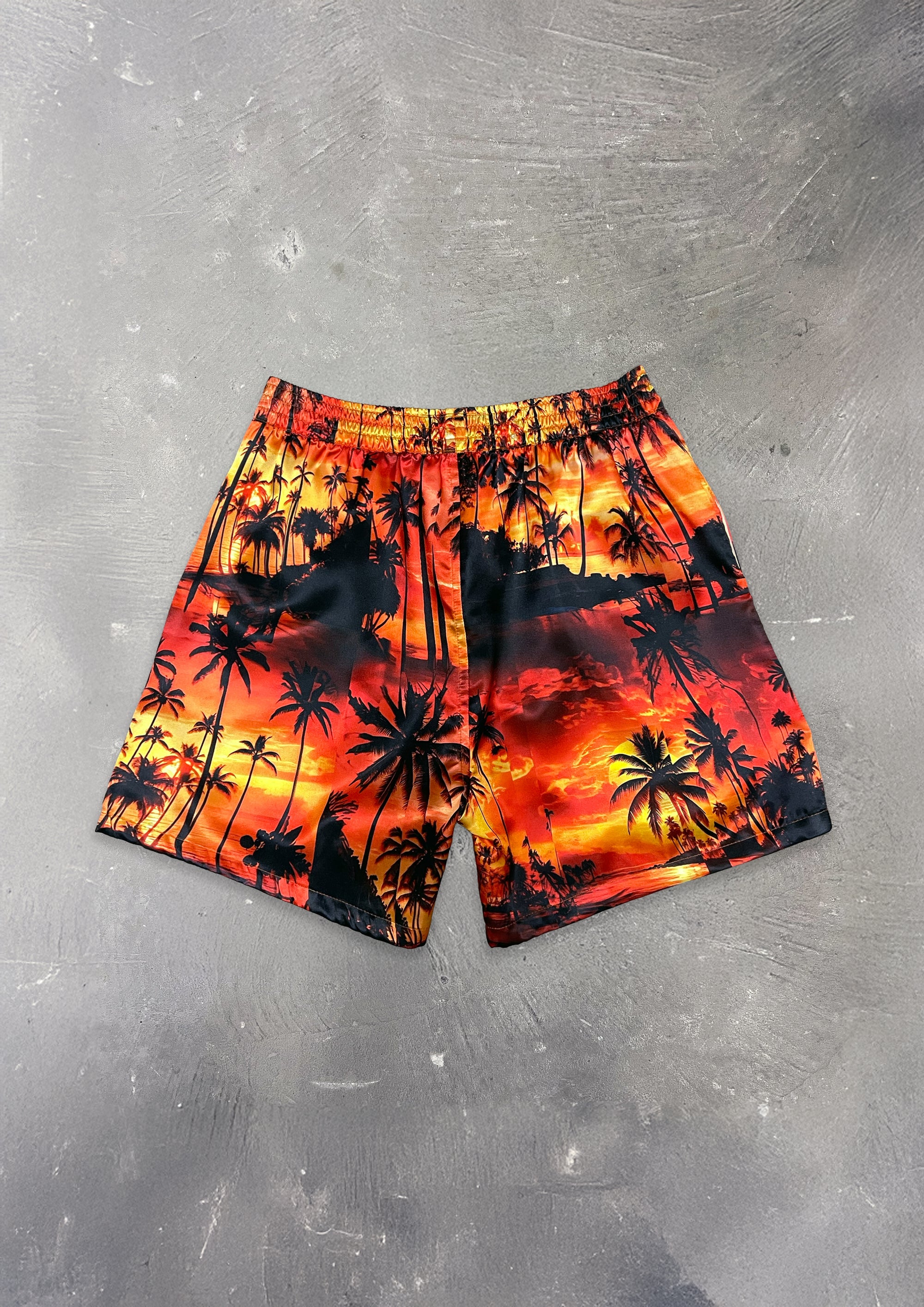 Shorts with palm tree design on a gray surface