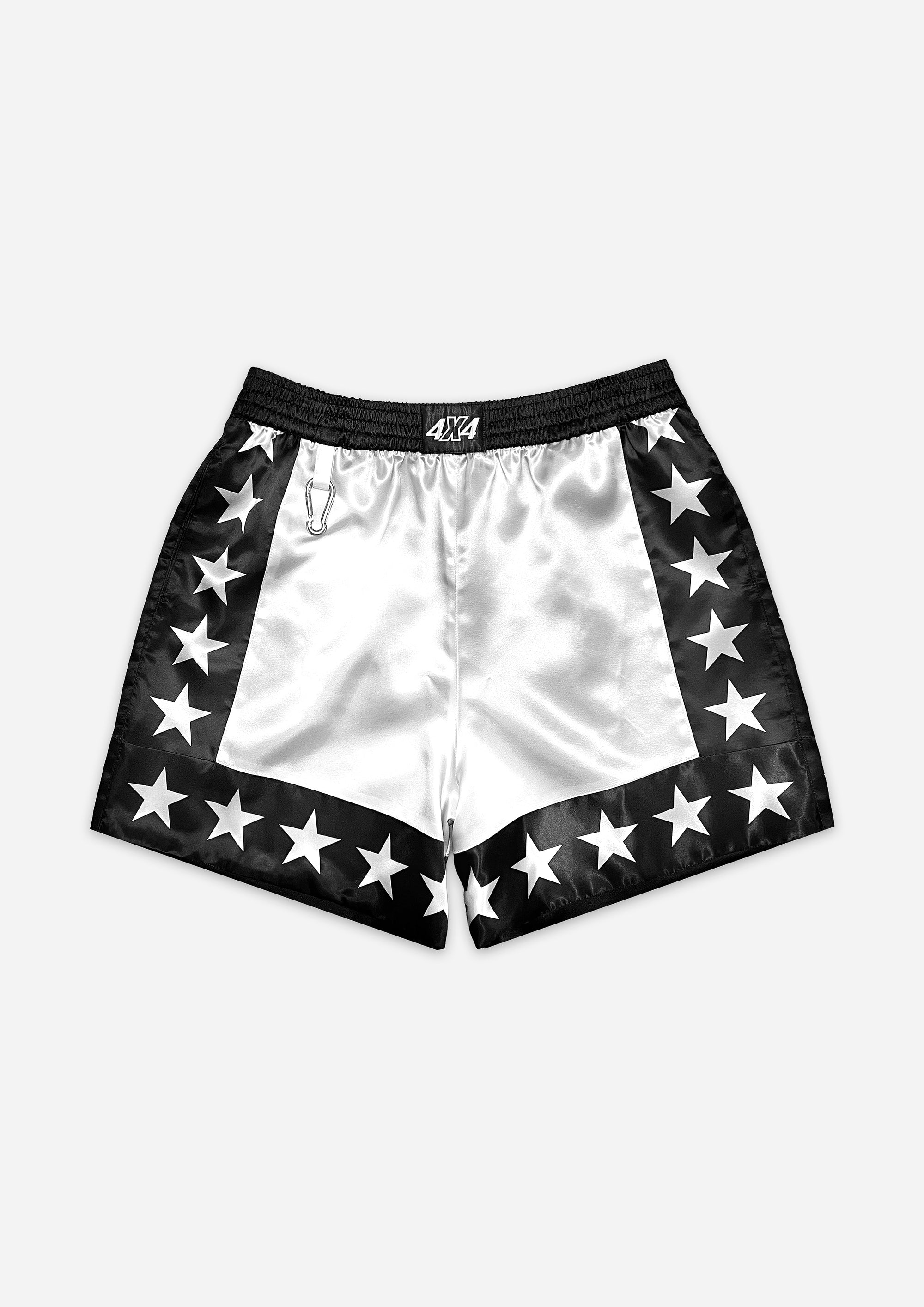 White shorts with black trim and star patterns on a white background