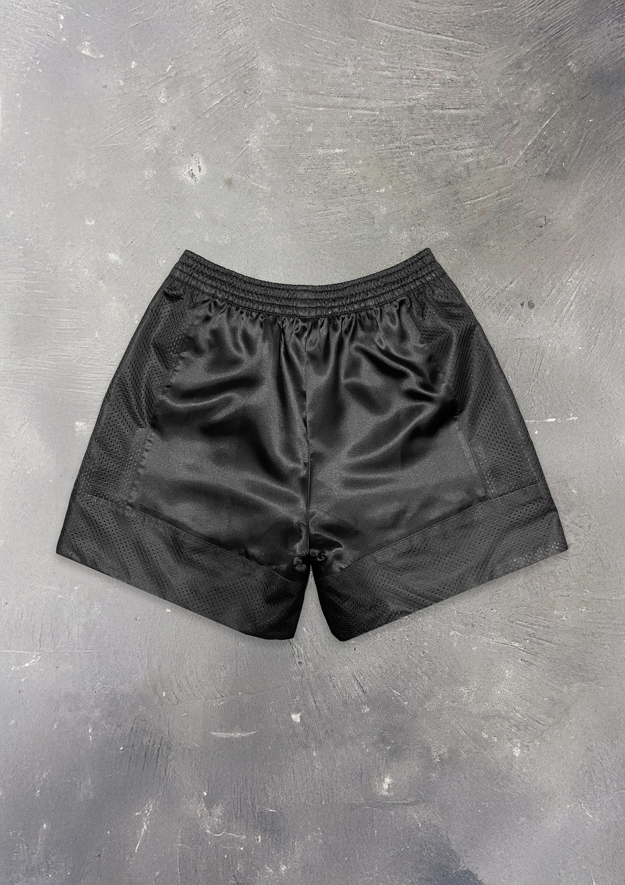 Black shorts on a textured gray surface