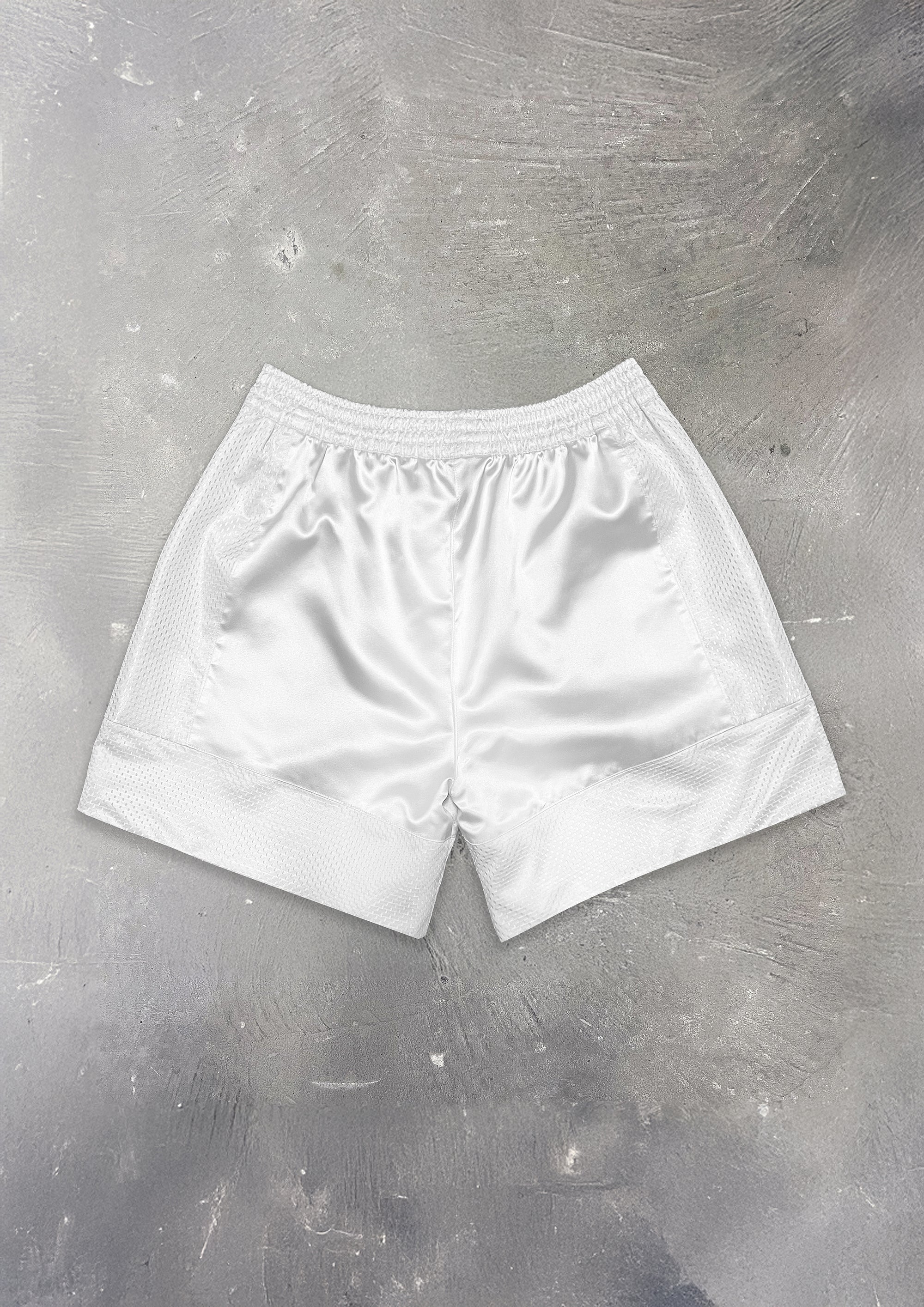 White shorts on a textured gray background