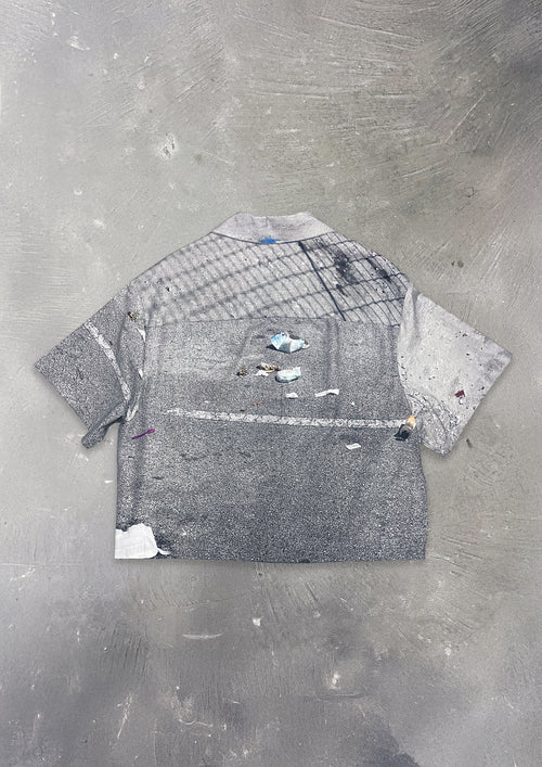 Gray textured shirt on a gray concrete surface