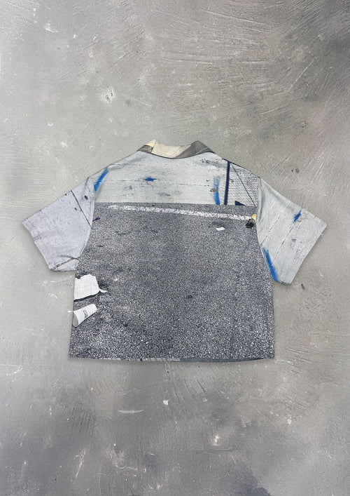 Gray t-shirt with abstract design on a textured gray surface
