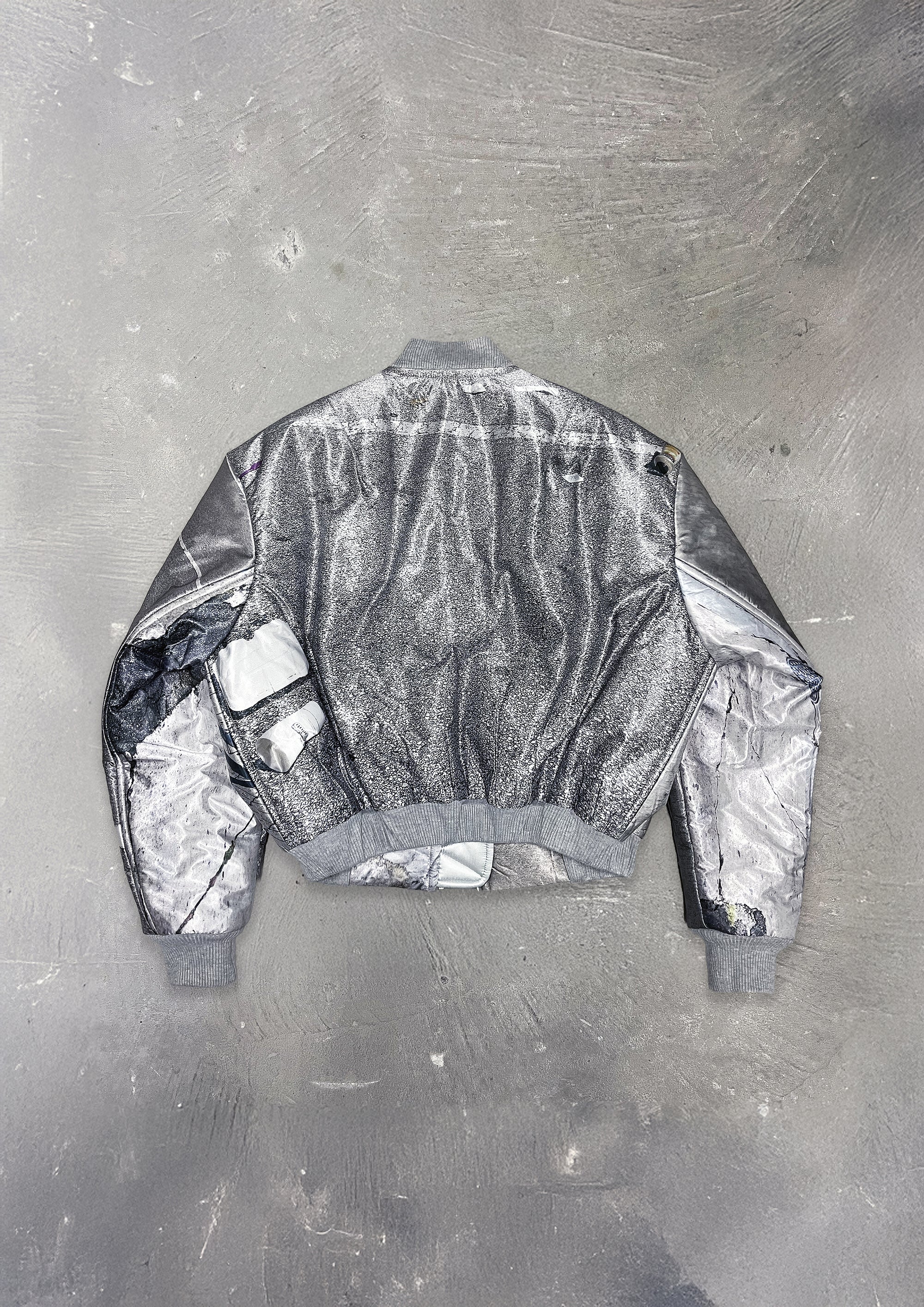Silver reflective jacket on a textured gray background